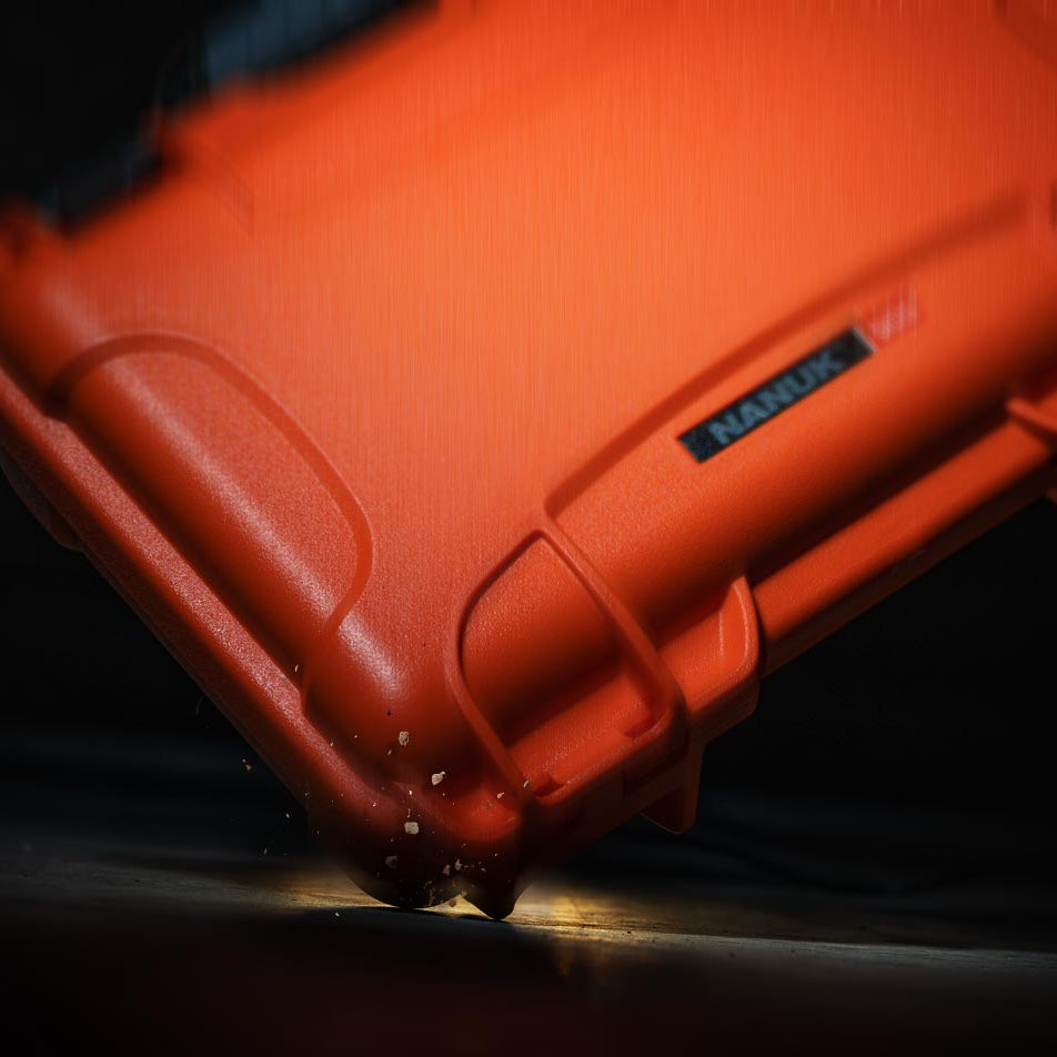 Red protective case with 'Nanuk' branding on a dark background