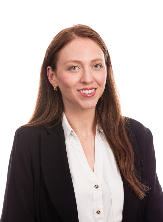 Woman wearing a black blazer and white shirt on a white background